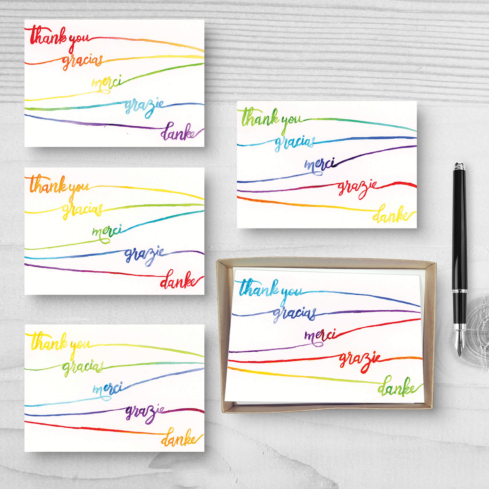 Set of five "Thank You" greeting cards with the phrase "thank you" in five languages and different rainbow gradients on each card